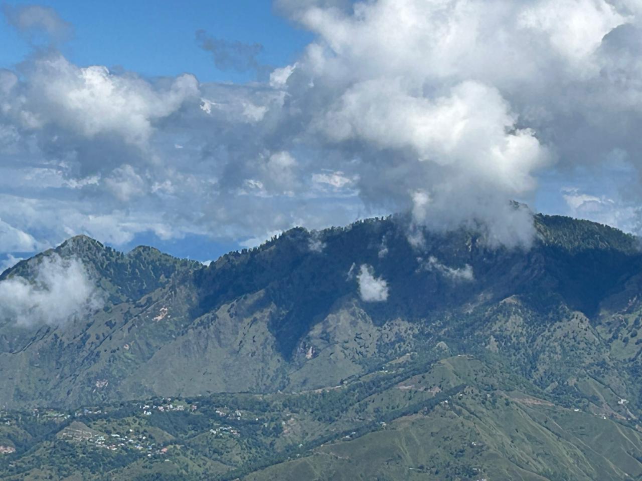 Monsoon cloud spilling over the forested summit